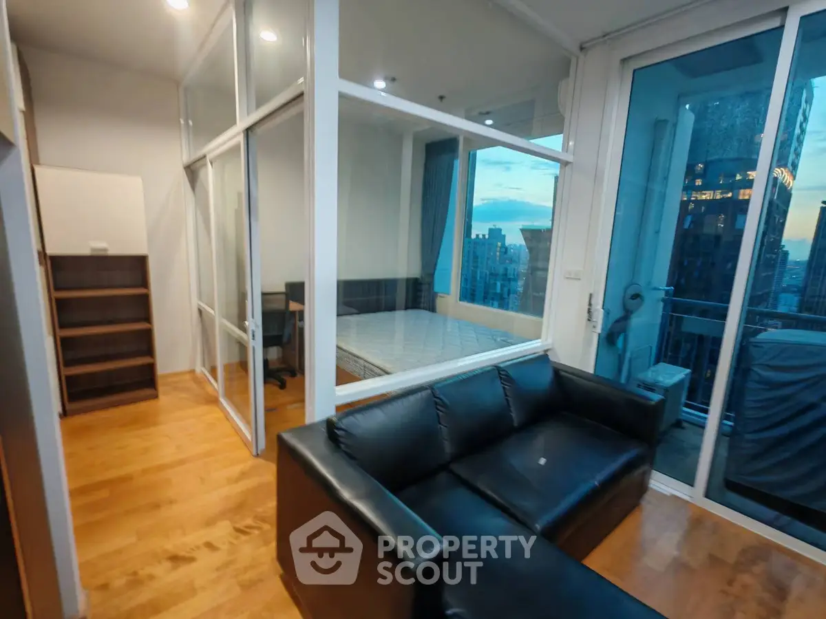 Modern apartment with glass-walled bedroom and city view balcony