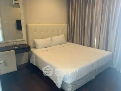 Cozy bedroom with elegant decor and natural light, perfect for relaxation.