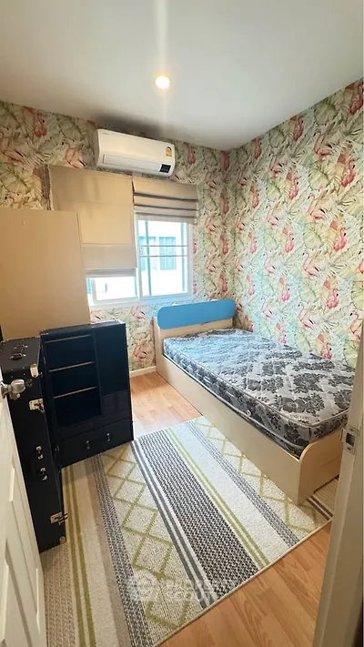 Cozy bedroom with floral wallpaper and modern furnishings