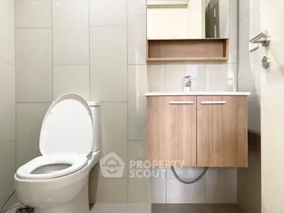 Modern bathroom with sleek fixtures and wooden vanity