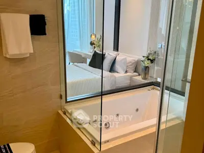 Luxurious bathroom with jacuzzi tub and view into elegant bedroom