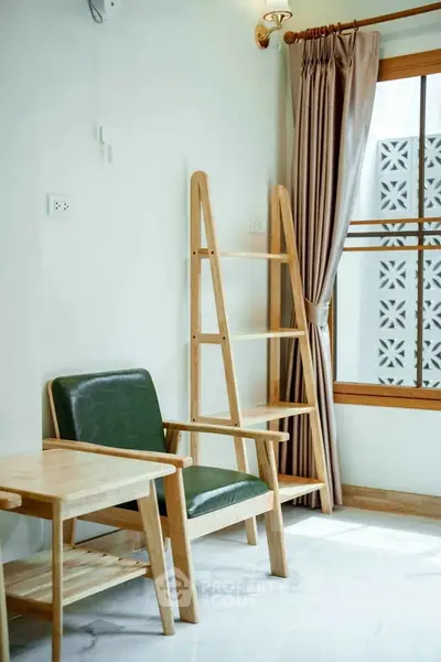Charming corner with stylish wooden furniture and natural light in a cozy living space.