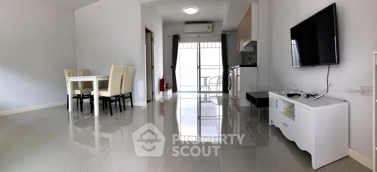 Modern living room with dining area and sleek kitchen in open layout