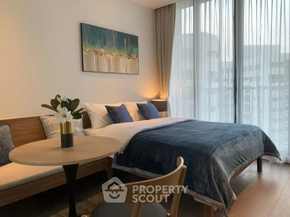 Elegant bedroom with modern decor and large window view in luxury apartment