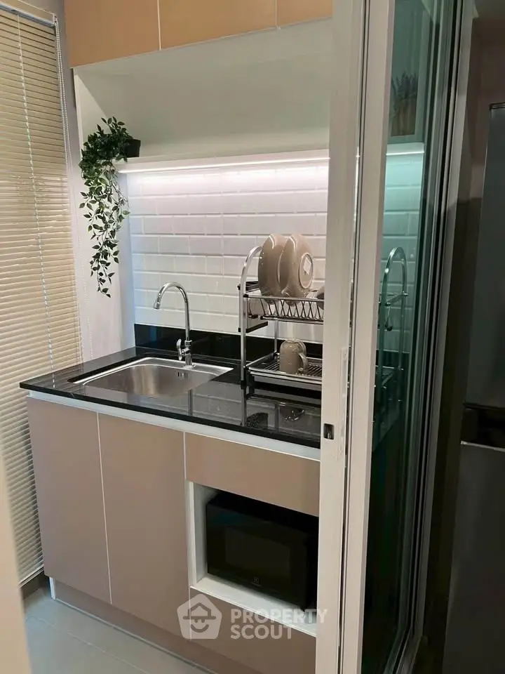 Modern compact kitchen with sleek cabinetry and stylish backsplash