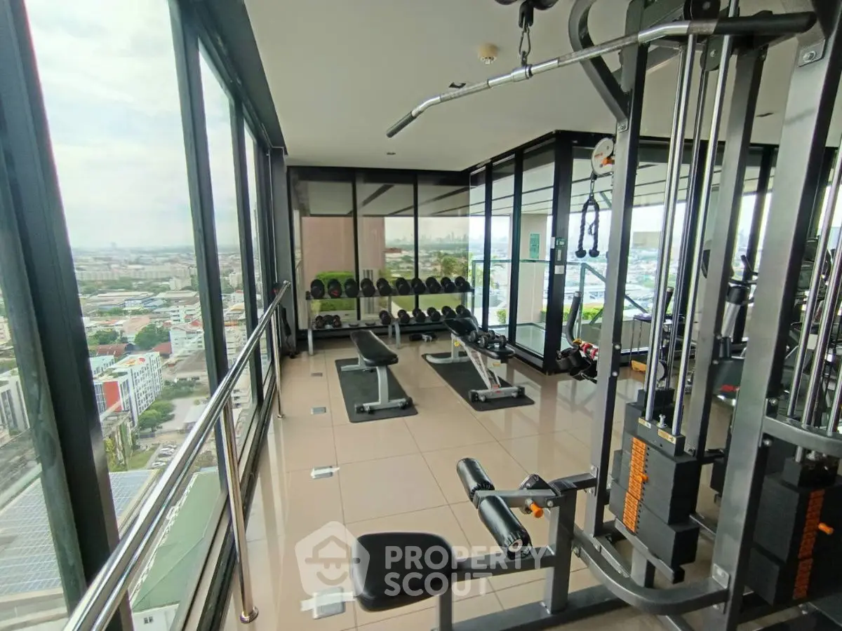 Modern high-rise gym with panoramic city views and state-of-the-art equipment.