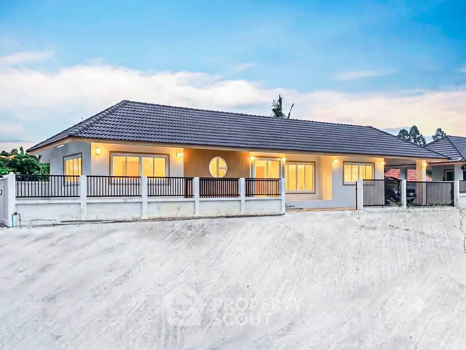 Modern single-story house with sleek design and spacious driveway, perfect for family living.
