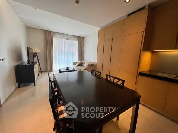Spacious modern living room with dining area and sleek furniture in a stylish apartment.