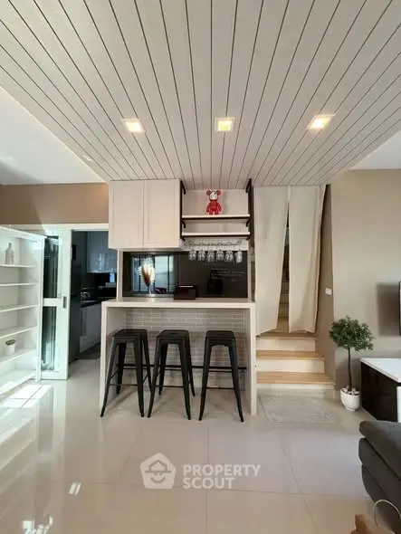 Modern kitchen with breakfast bar and stylish lighting