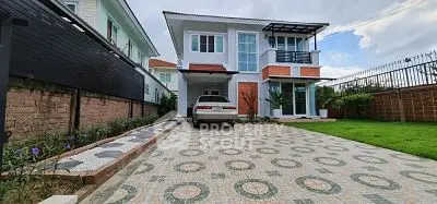 Spacious modern house with driveway and lush garden in serene neighborhood