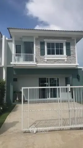 Charming two-story house with modern facade and gated driveway