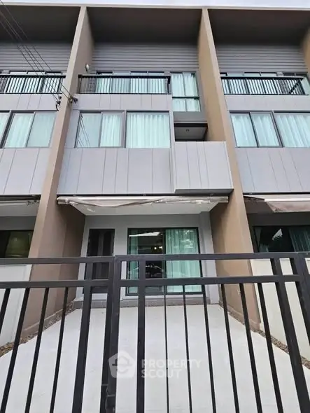 Modern townhouse exterior with sleek design and large windows, perfect for urban living.