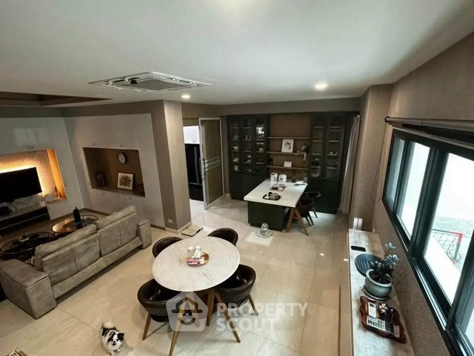 Spacious modern living room with open layout and stylish dining area, perfect for entertaining.