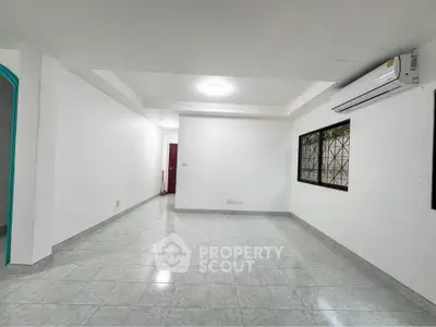 Spacious living room with modern air conditioning and large window, perfect for comfortable living.