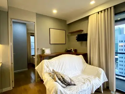 Cozy living room with modern decor and city view balcony access.