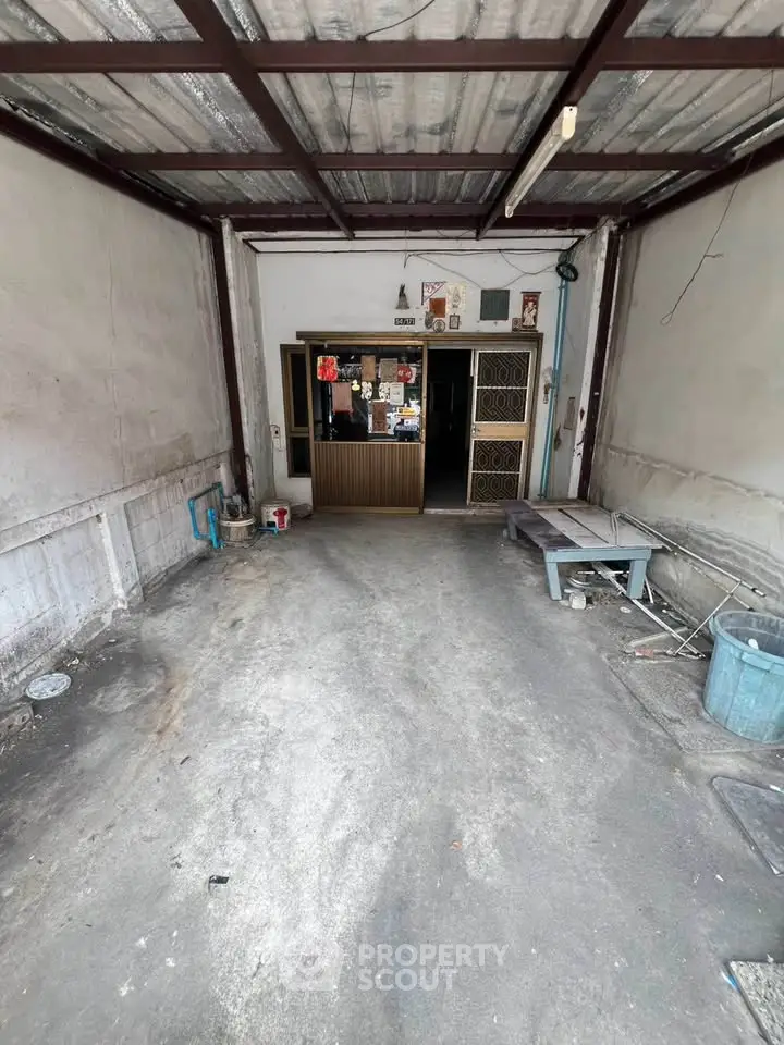 Spacious garage with metal roof and concrete floor, ideal for storage or parking.