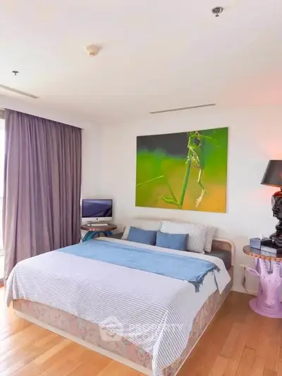 Spacious bedroom with modern decor and large window for natural light