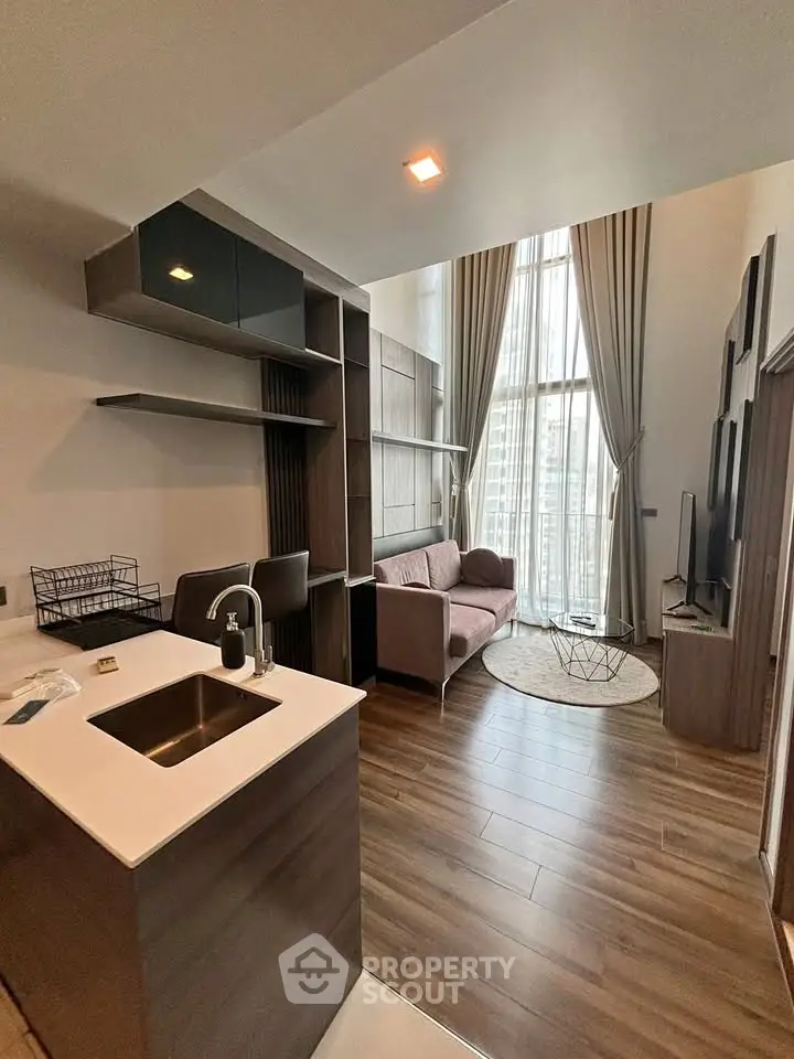 Modern loft apartment with high ceilings and stylish interior design, featuring a cozy living area and open kitchen.