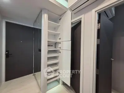 Modern apartment entrance with sleek storage and air conditioning