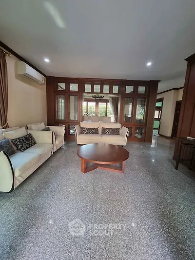 Spacious living room with elegant sofas and large windows in a modern home