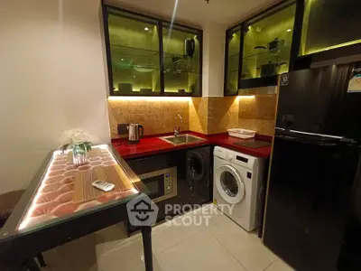 Modern kitchen with red countertops, washing machine, and elegant lighting