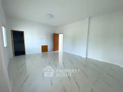 Spacious empty room with glossy white tile flooring and wooden doors