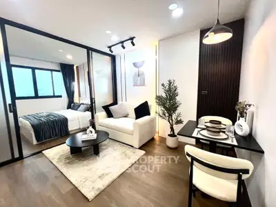 Modern open-plan living room with stylish decor and cozy bedroom view