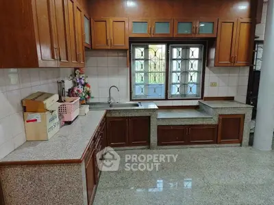 Spacious kitchen with granite countertops and wooden cabinets