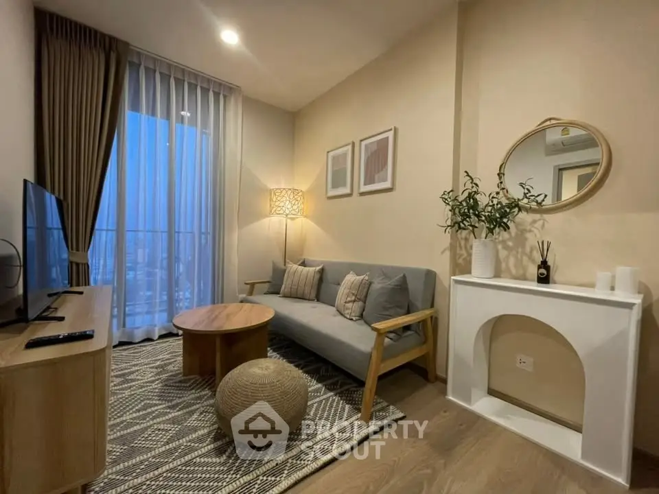 Stylish modern living room with cozy sofa, elegant decor, and city view balcony.
