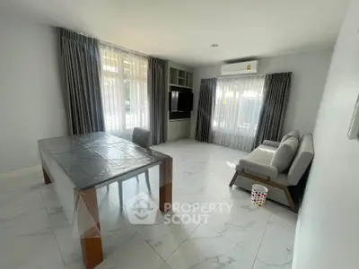 Spacious living room with modern furniture and large windows for natural light.