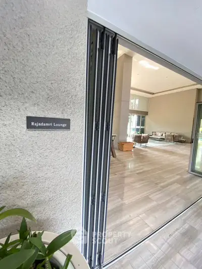 Spacious lounge area with modern decor and large windows for natural light.