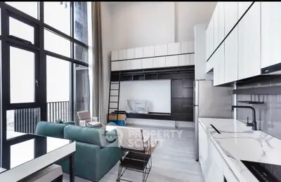 Modern open-plan living room with high ceilings and sleek kitchen design