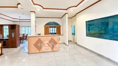 Spacious open-plan living area with elegant wood accents and ample natural light.