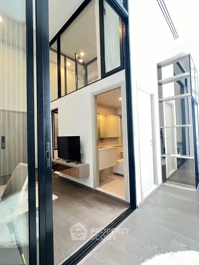 Modern duplex apartment with sleek design and high ceilings, featuring a cozy living area and stylish bathroom.