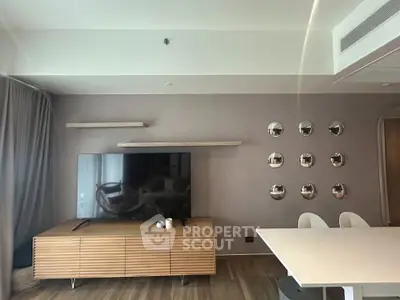 Modern living room with sleek TV setup and stylish wall decor