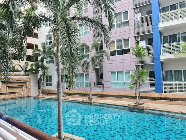 Modern apartment building with pool and palm trees, perfect for urban living.