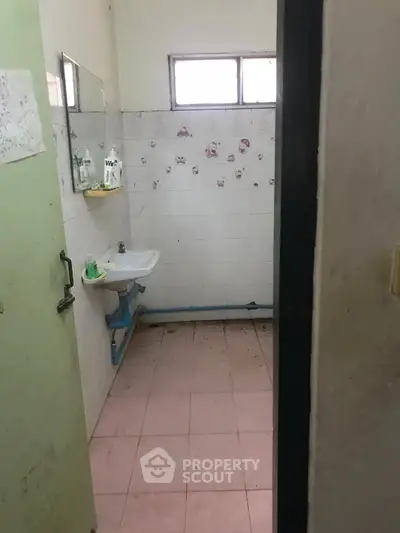 Basic bathroom with sink and tiled walls, minimalistic design