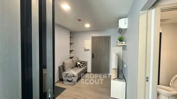 Modern living room with sleek design and cozy seating in a stylish apartment.