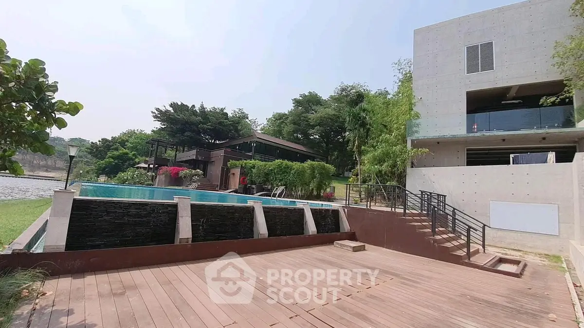 Luxurious modern villa with stunning pool and lush greenery, perfect for serene living.