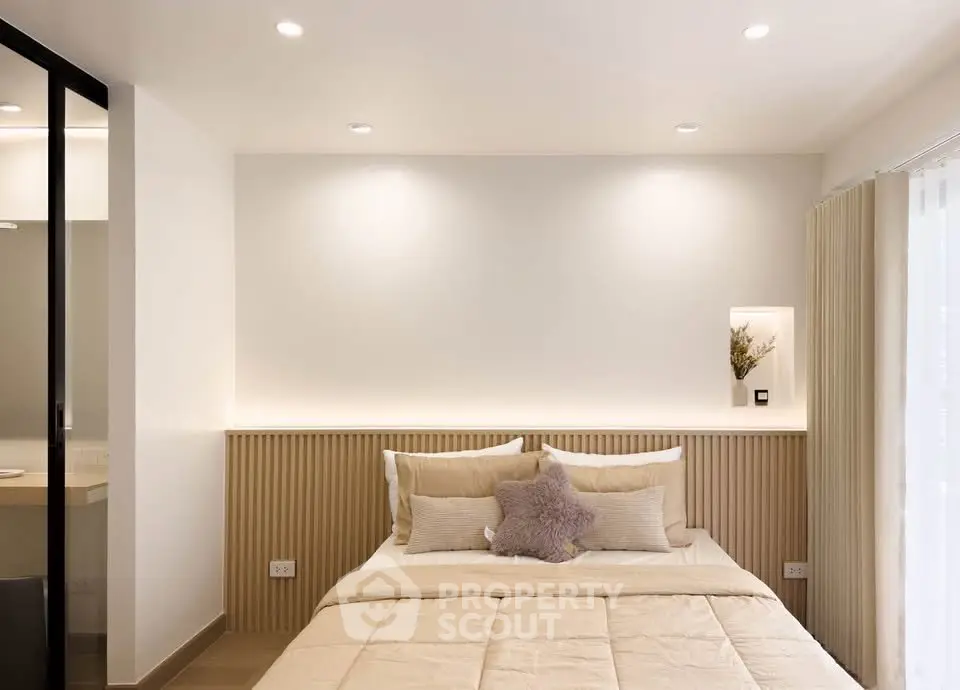Modern minimalist bedroom with cozy lighting and neutral decor