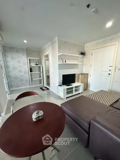 Modern living room with stylish furniture and TV, perfect for relaxation and entertainment.
