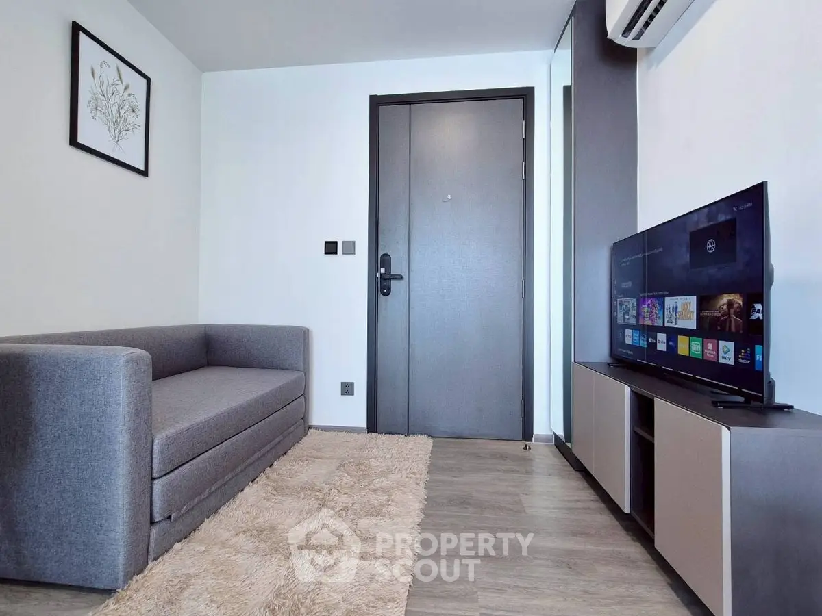 Modern living room with sleek furniture and wall-mounted TV, perfect for cozy relaxation.