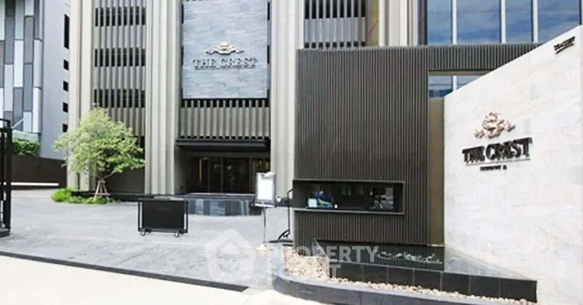 Luxurious modern building entrance with sleek architectural design and elegant signage.