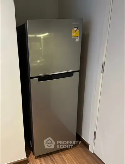 Modern stainless steel refrigerator in a sleek kitchen corner