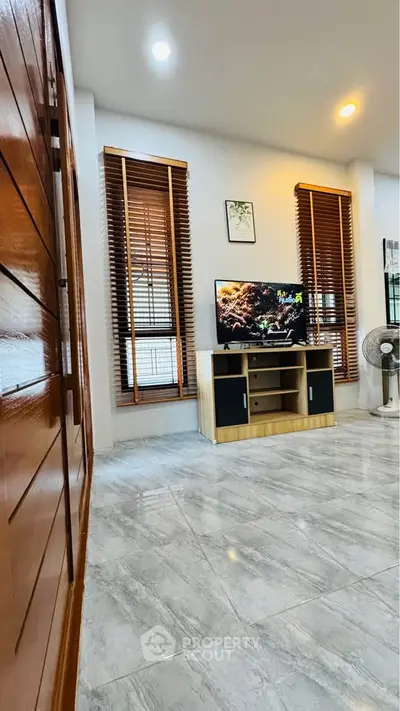 Modern living room with stylish wooden blinds and sleek TV stand