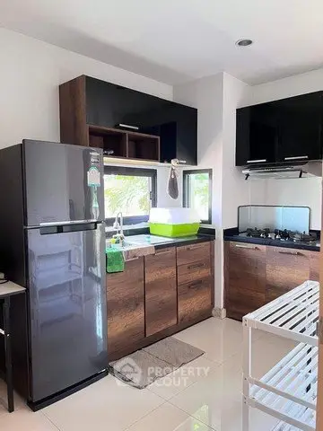 Modern kitchen with sleek black appliances and wooden cabinets