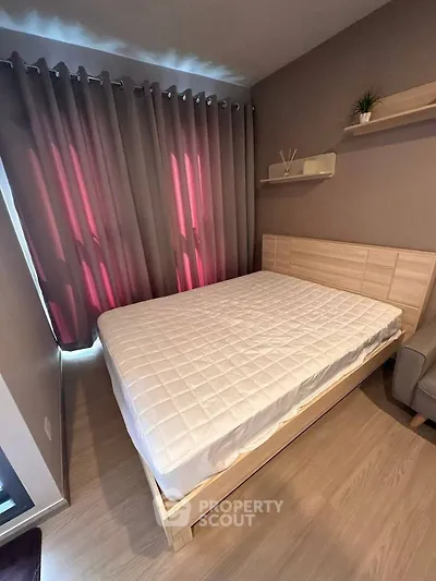 Cozy bedroom with modern decor and natural light, featuring a comfortable bed and stylish curtains.