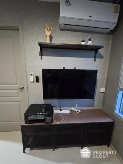 Modern living room with wall-mounted TV and air conditioning unit