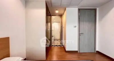 Modern bedroom with ensuite bathroom and wooden flooring