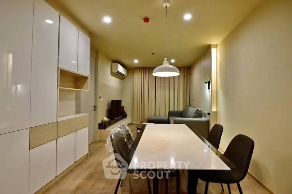 Modern living room with sleek furniture and ambient lighting, perfect for cozy gatherings.